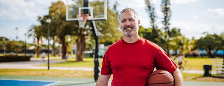 Man holding basketball on basketball court