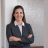 Professional headshot of Andrea S. Hewitt, Esq., personal injury and appeals attorney, wearing a black plaid blazer and leaning against a white pillar.