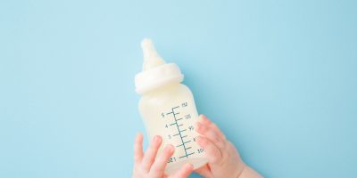 Baby Holding Baby Bottle