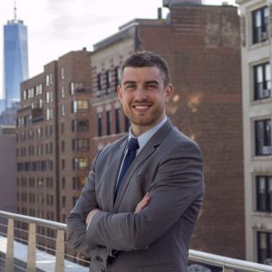 Man smiling, wearing a suit