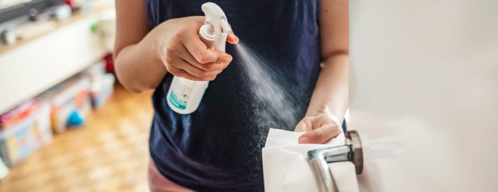 Person spraying cleaning product near their skin