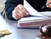 Judge with gavel and folder of documents