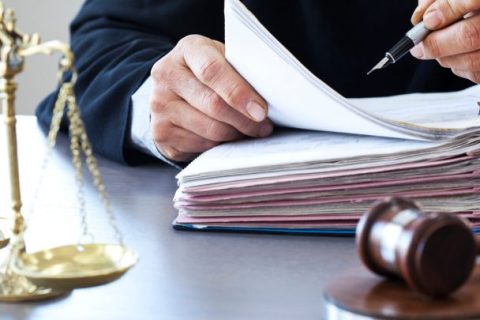 Judge with gavel and folder of documents