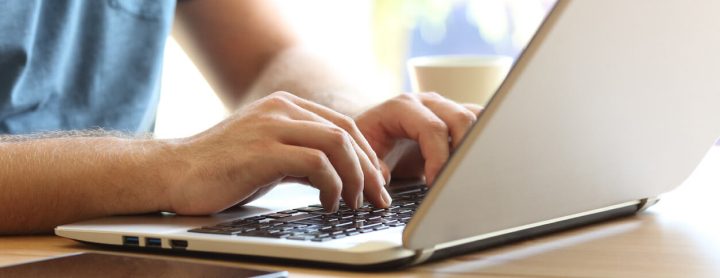 Person searching on laptop computer