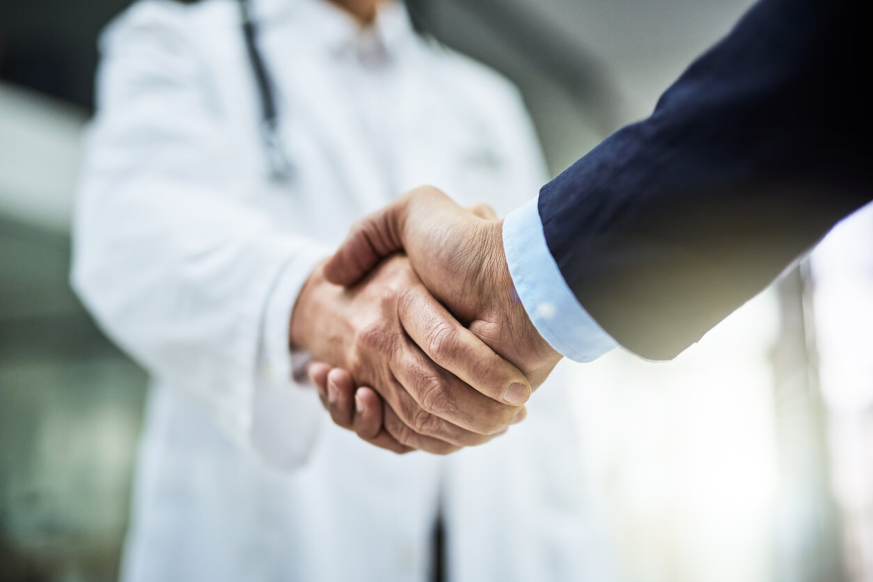 doctor shaking businessman's hand