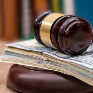 Gavel sitting on top of money