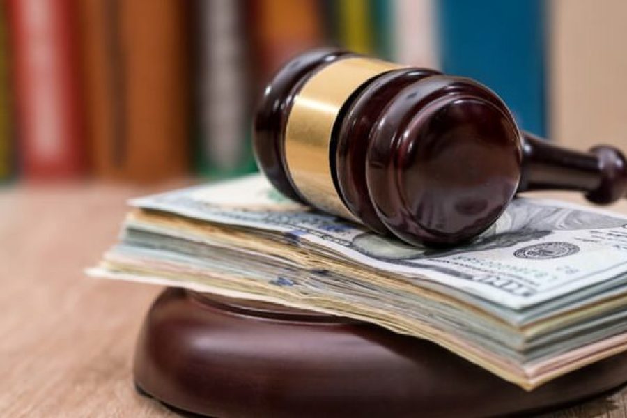 Gavel sitting on top of money