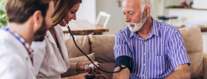 Man gets blood pressure checked by doctor