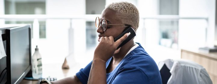 Hospital receptionist speaking to someone on the phone