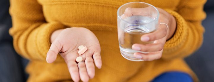 Woman taking antibiotics with water