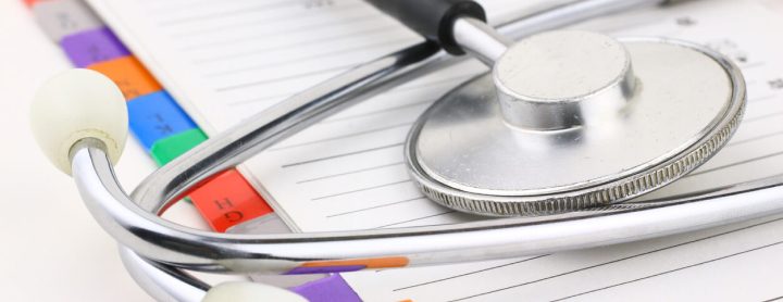 Medical file folder under stethoscope