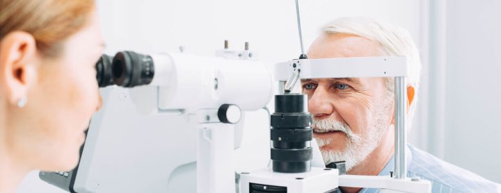 Man getting eyes checked by doctor