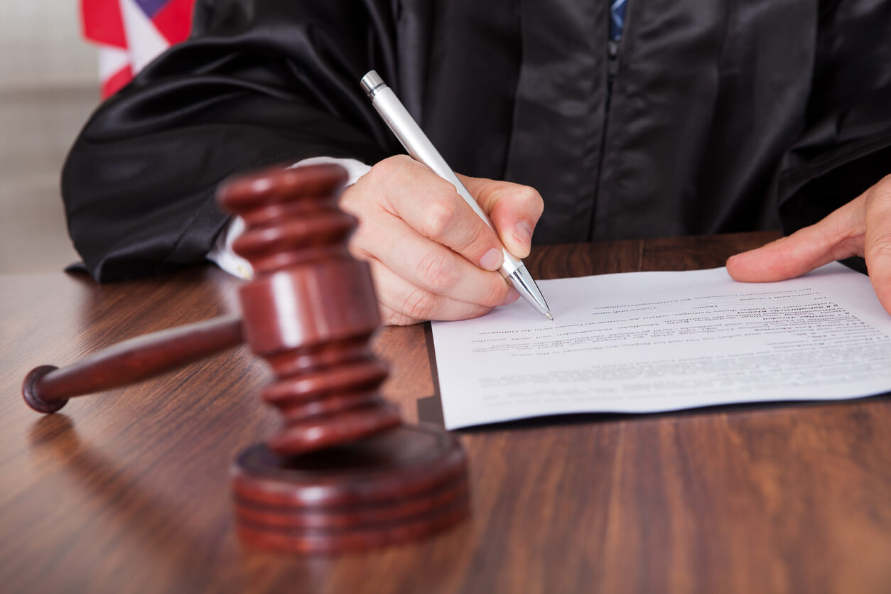 Judge with gavel signing a contract