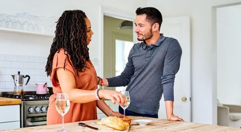 Transgender male with his wife at breakfast table in kitchen