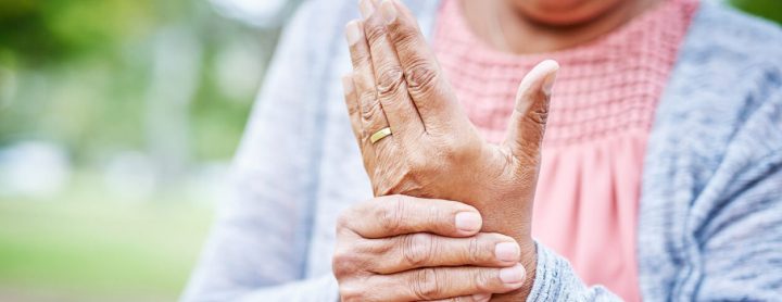 Woman holding her aching wrist