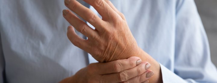 Person with joint pain in their hands due to lupus