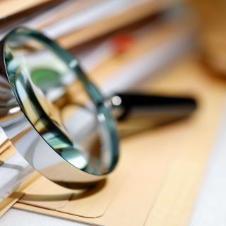 Magnifying glass next to files