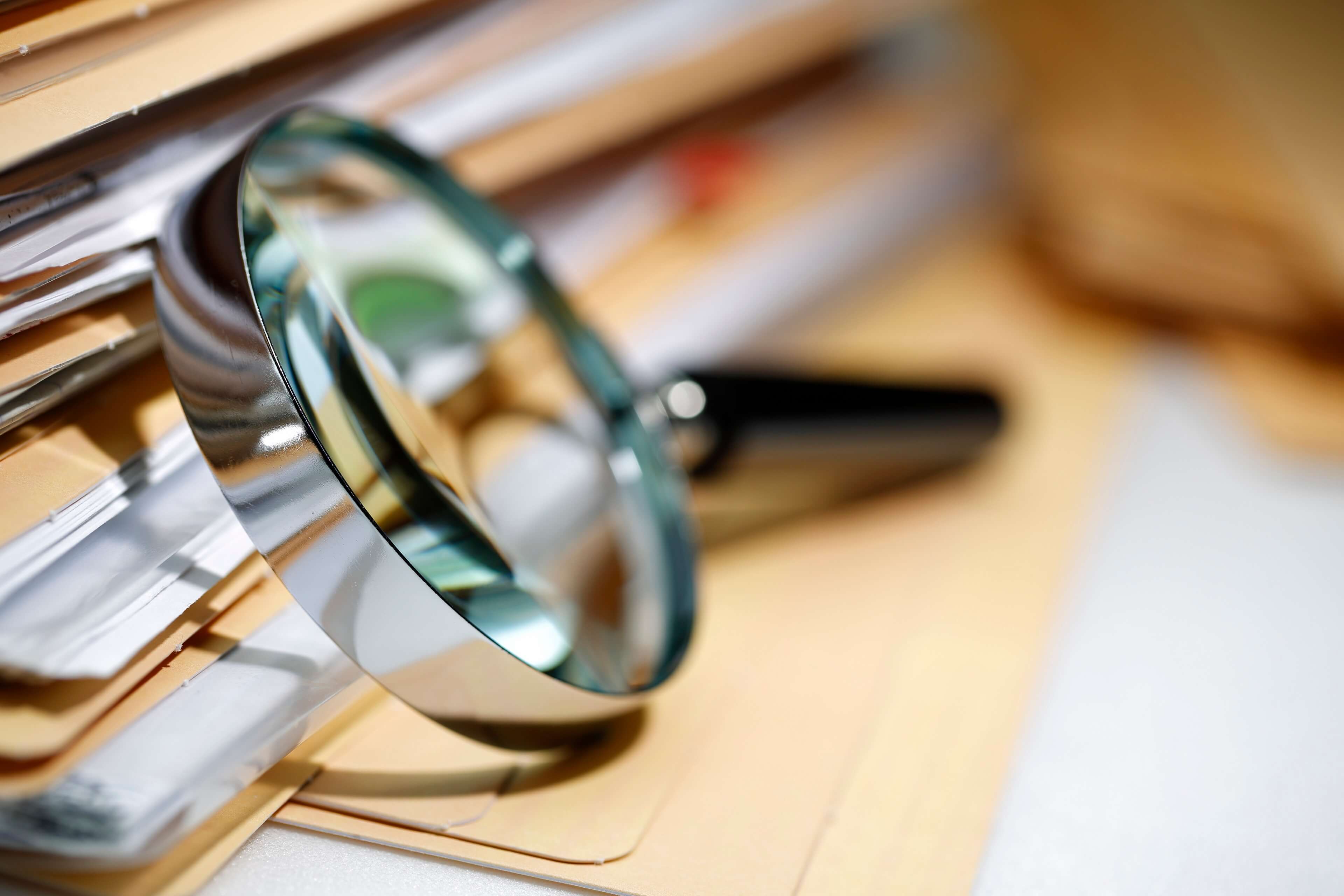 Magnifying glass next to files