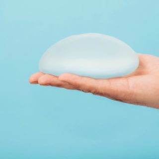 Man holding breast implant