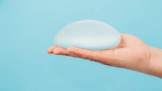 Man holding breast implant