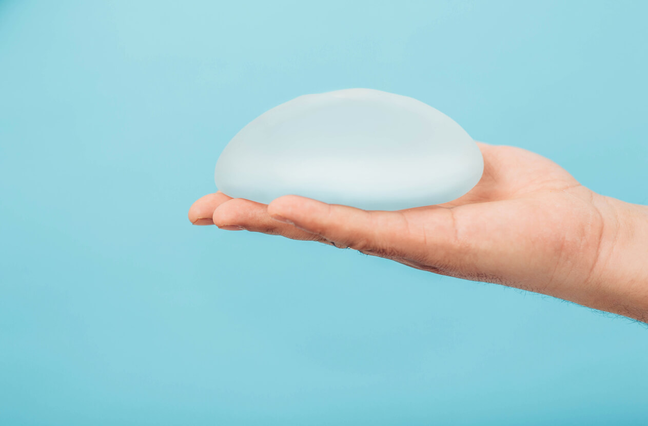 Man holding breast implant