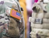 US flag on camouflage shirt