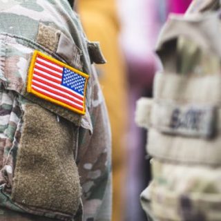 US flag on camouflage shirt
