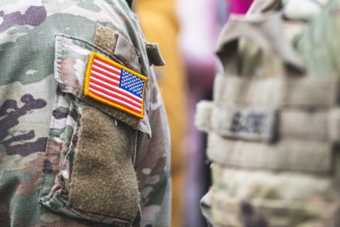 US flag on camouflage shirt