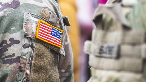 US flag on camouflage shirt