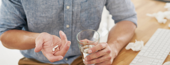 Man taking his medication with water