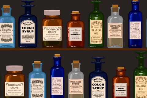 Old apothecary. Vintage bottles on wooden shelves.