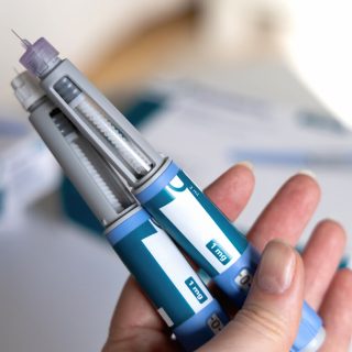 Woman holding two ozempic pens