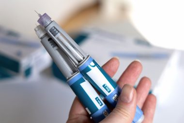 Woman holding two ozempic pens