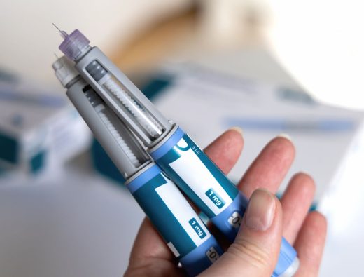 Woman holding two ozempic pens