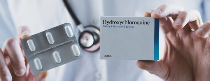 Doctor holding hydroxychloroquine pill box