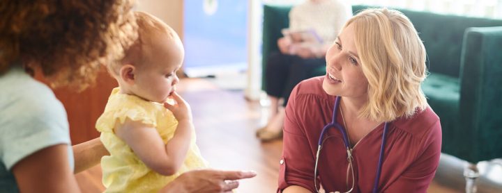 Mother with her toddler talking to a doctor