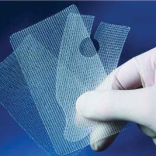 Gloved hands holding Transvaginal Mesh