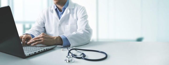 Dcotor at computer with stethoscope