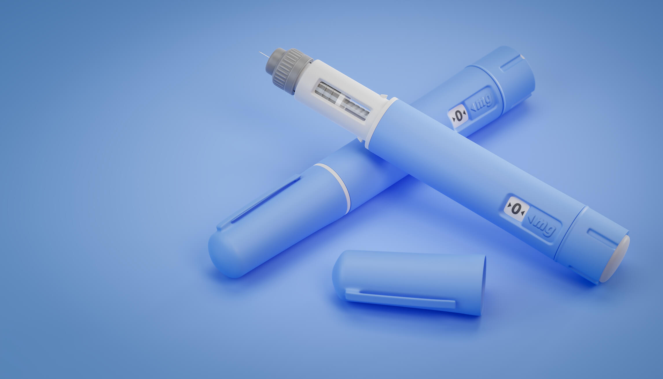 Blue semaglutide injection pens on blue background, one with cap removed showing needle.