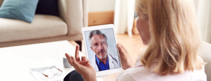 Female patient explains health concerns to doctor over telemedicine visit