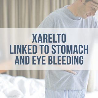 man in his bedroom, holding his head and stomach