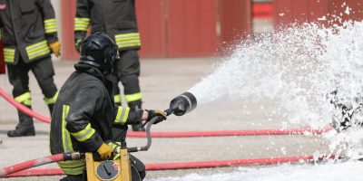 Firefighrer spraying AFFF foam