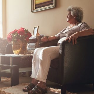 Older woman looking out the window