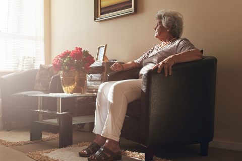 Older woman looking out the window