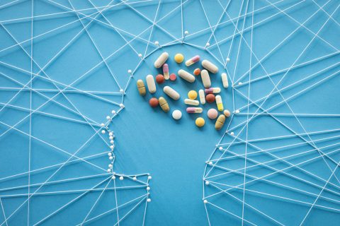 human head made out of pins and threads with antidepressants shaping the brain