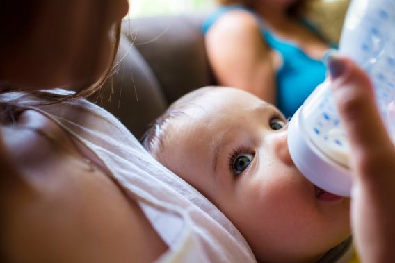 Baby being fed with a bottle