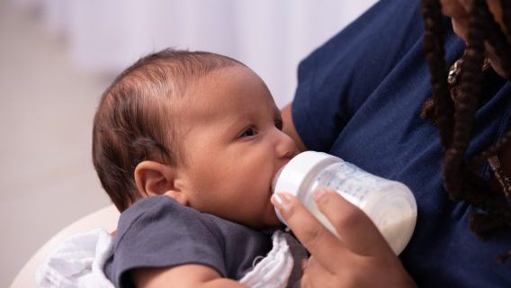 Baby being fed from a bottle
