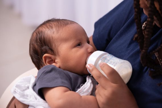 Baby being fed from a bottle
