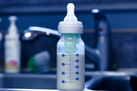 Baby bottle with formula on kitchen sink