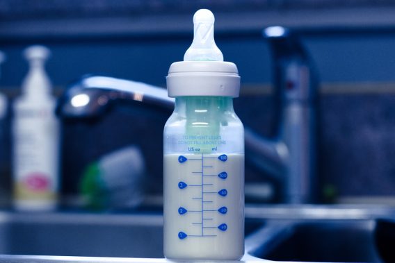 Baby bottle with formula on kitchen sink